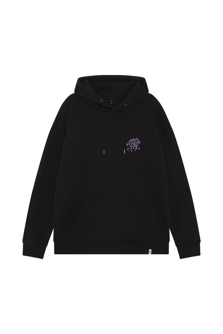Front of a black unisex organic cotton hoodie in a drop shoulder fit, with a purple flower graphic printed on the front, drawstring and ribbed hem and cuffs.