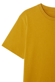 Sleeve detail and ribbed collar of men's organic cotton t-shirt in mustard yellow, made from medium weight organic cotton