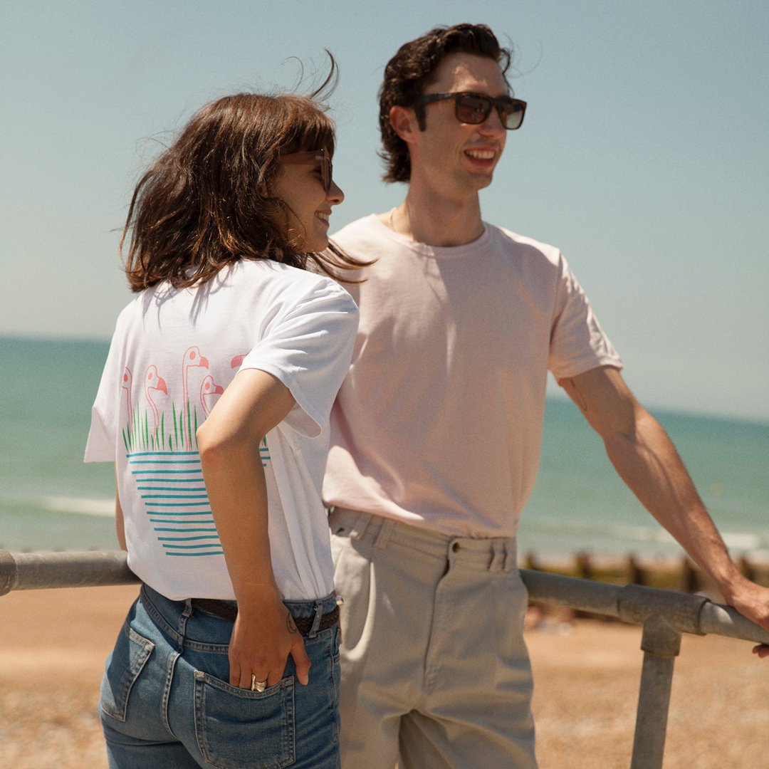 Man and woman wearing organic cotton t-shirts with flamingo print on them from sustainable fashion brand Goose Studios