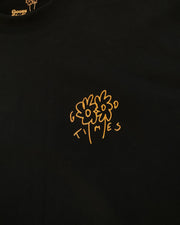 Black t-shirt with an orange hand drawn logo featuring the Goose Studios flowers with the words Good Times incorporated intro the design, printed on a black heavyweight organic cotton t-shirt.