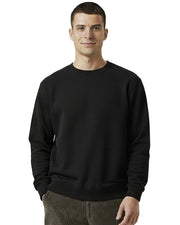 Person wearing an organic cotton black sweatshirt from Goose Studios and grey cord trousers on a white background