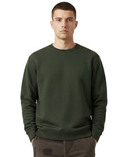 Man wearing an olive green organic cotton sweatshirt from organic clothing brand Goose Studios, together with patterned cord trousers from Patta