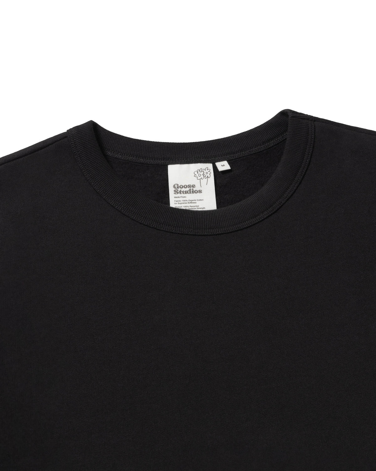 Detail image of Goose Studios men's organic cotton sweatshirt in black with custom label detail.