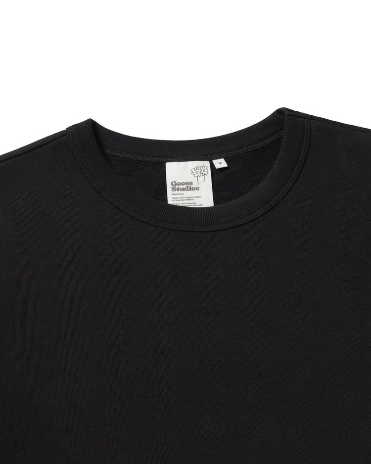 Detail image of Goose Studios men's organic cotton sweatshirt in black with custom label detail.