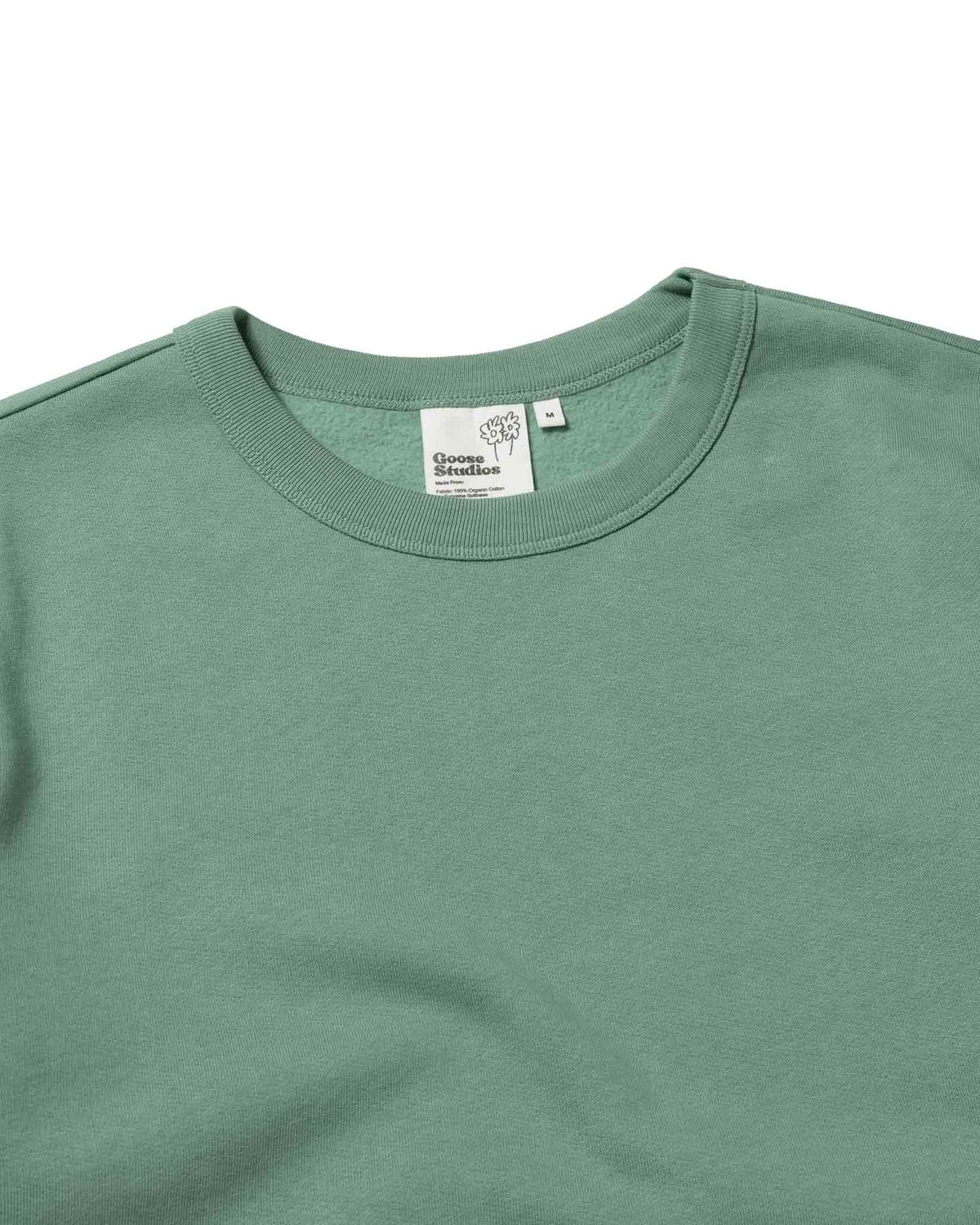 Collar detail and custom label on Goose Studios organic cotton sweatshirt in plain green designed specifically for men