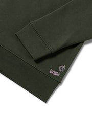 Detail shot focussed on the organic cotton jersey in olive green of a men's sweatshirt by Goose Studios, who's screen printed logo in lilac can be seen, signifying a premium line from Goose Studios' collection