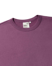 Close up of a purple organic cotton mens sweatshirt with an organic cotton rib collar and white label detailing the brand, Goose Studios