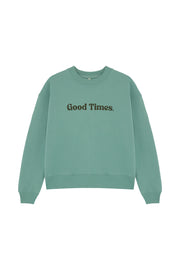 Front of women's organic cotton sweatshirt in green with a drop shoulder, boxy fit and Good Times text print across the front chest. Made by sustainable clothing brand Goose Studios