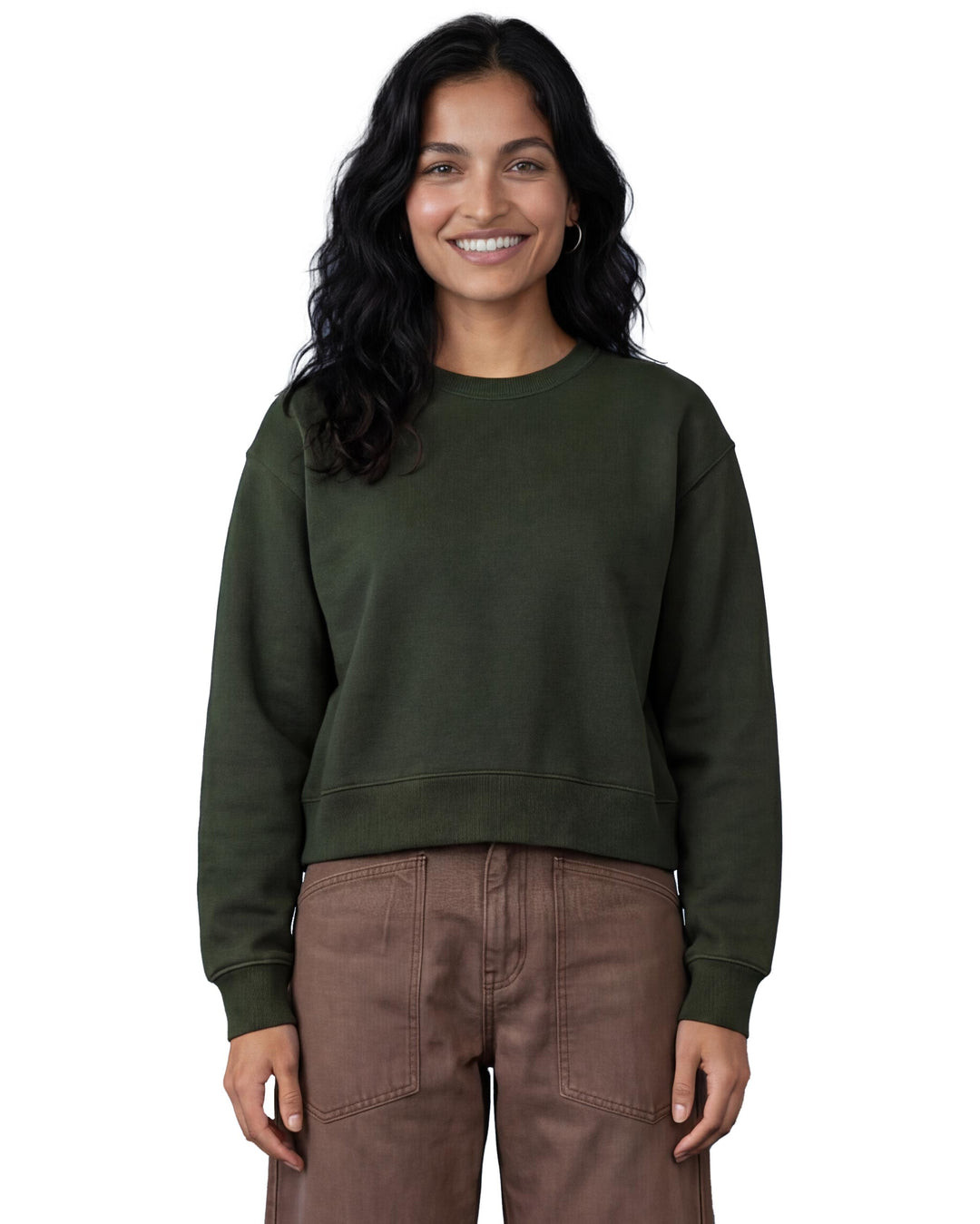 Woman wearing a green organic cotton sweatshirt and brown canvas trousers on a white background