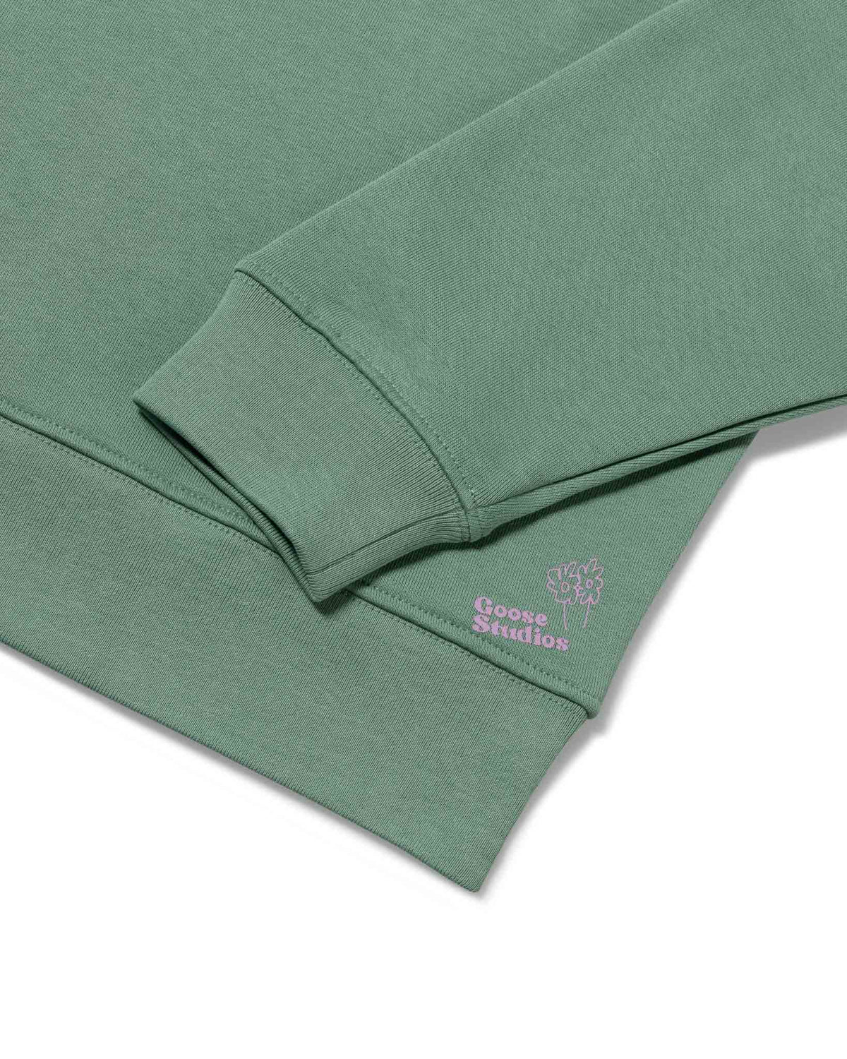 Cuff detail of women's organic cotton sweatshirt in pastel green