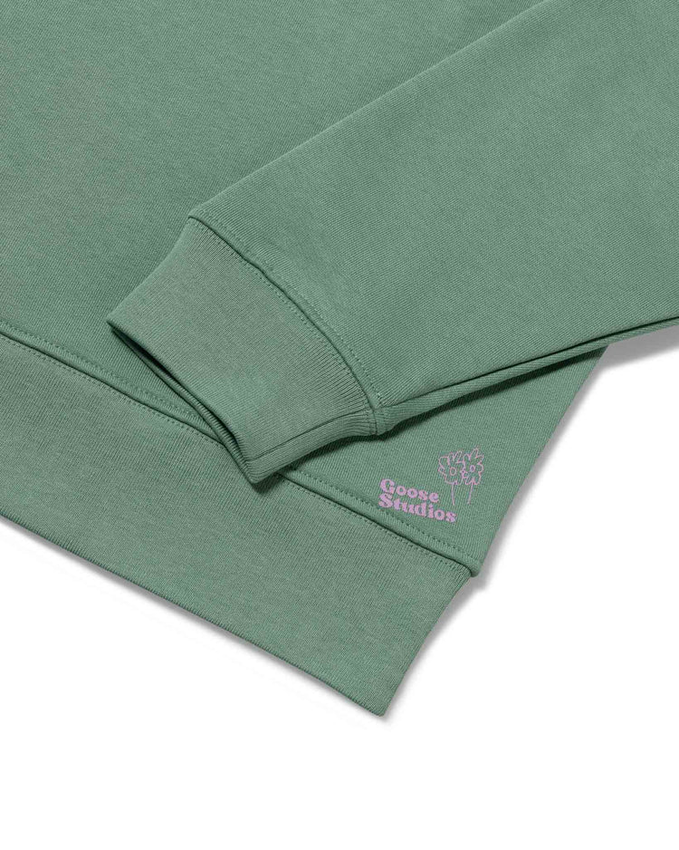 Cuff detail of women's organic cotton sweatshirt in pastel green