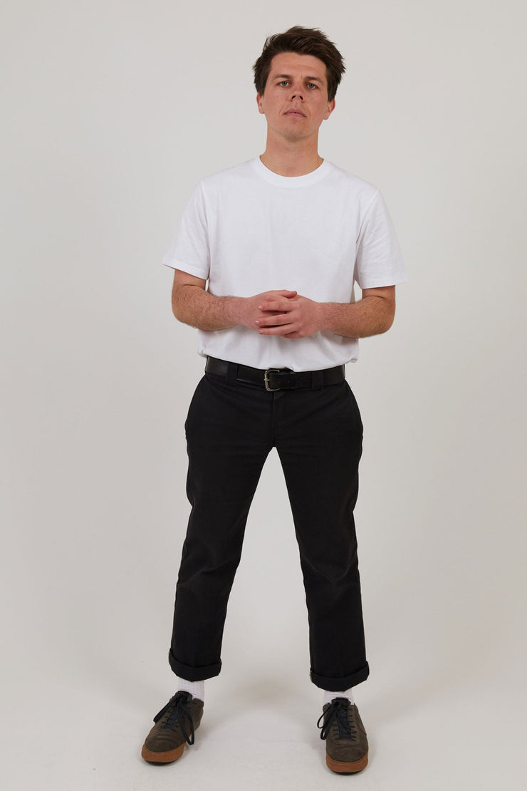 Man wearing white workwear organic cotton t shirt and organic cotton jeans