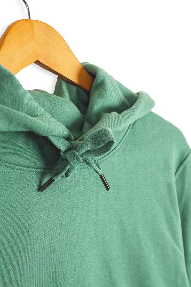 Drawstring detail of sustainable hoodie in green organic cotton.