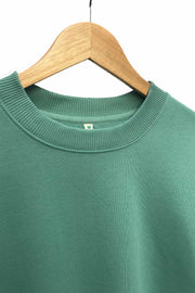 Collar detail of women's organic cotton sweatshirt in pastel green